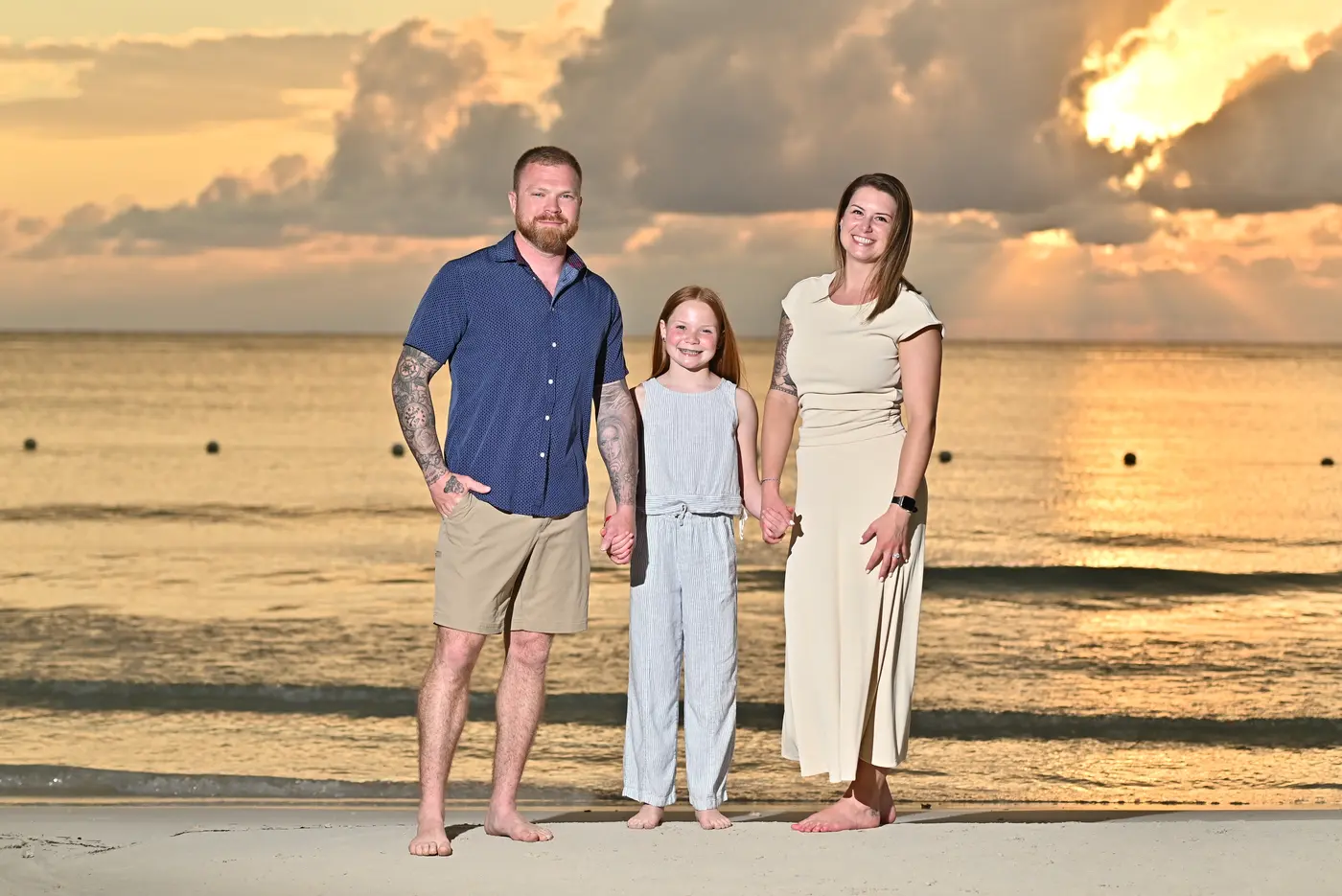 Me with my wife and daughter on the beach at sunset
